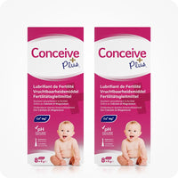 Conceive Plus Fertility Lubricant, Pre-Filled Applicators (FR) 8-pack box with dual applicators displayed beside it. The packaging is trilingual—French, Dutch, and German—and highlights pH balanced formula with calcium and magnesium ions. Pink and white color palette features a baby image and icons for fertility support.